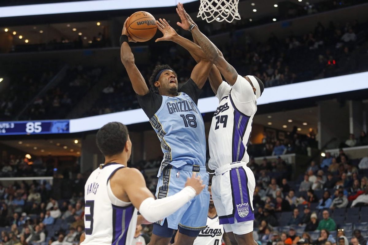 Feb 23, 2026; Memphis, Tennessee, USA; Memphis Grizzlies forward Olivier-Maxence Prosper (18) shoots as Sacramento Kings guard Daeqwon Plowden (29) defends during the third quarter at FedExForum. Mandatory Credit: Petre Thomas-Imagn Images