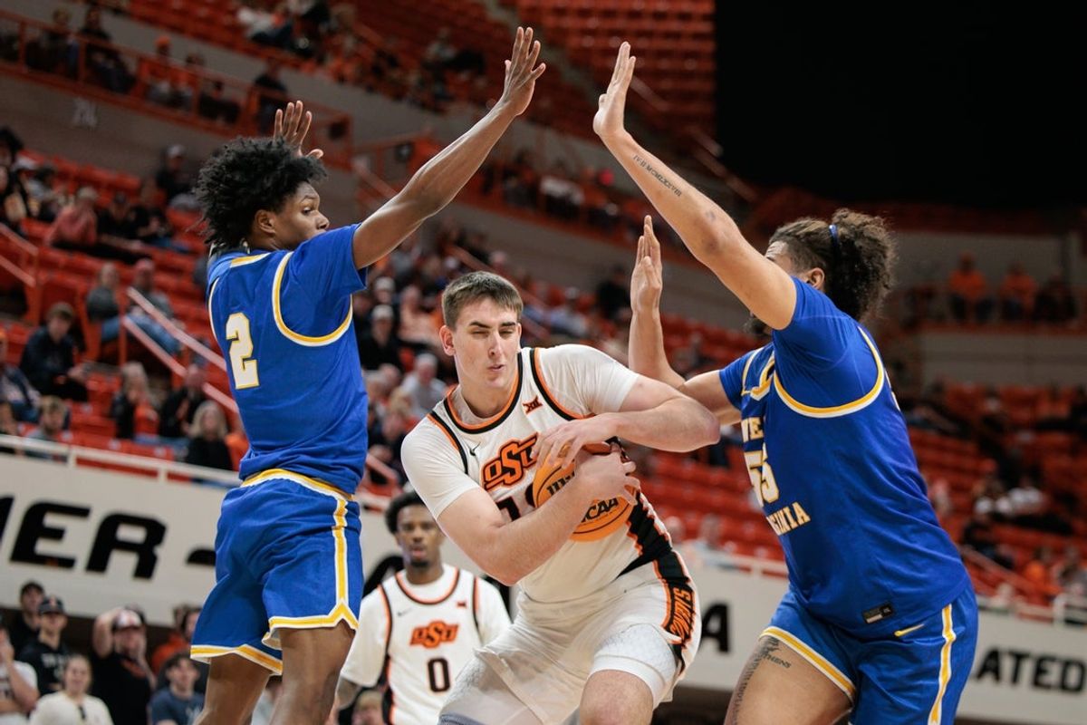 Feb 24, 2026; Stillwater, Oklahoma, USA; Oklahoma State Cowboys forward Andrija Vukovic (19) protects the ball between West Virginia Mountaineers guard Amir Jenkins (2) and West Virginia Mountaineers center Harlan Obioha (55) during the first half at Gallagher-Iba Arena. Mandatory Credit: William Purnell-Imagn Images