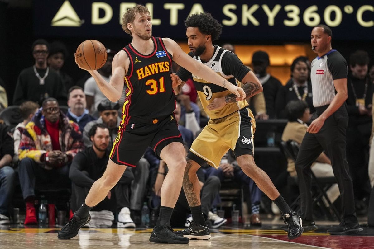 Feb 24, 2026; Atlanta, Georgia, USA; Atlanta Hawks center Jock Landale (31) passes in front of Washington Wizards forward Justin Champagnie (9) during the first half at State Farm Arena. Mandatory Credit: Dale Zanine-Imagn Images