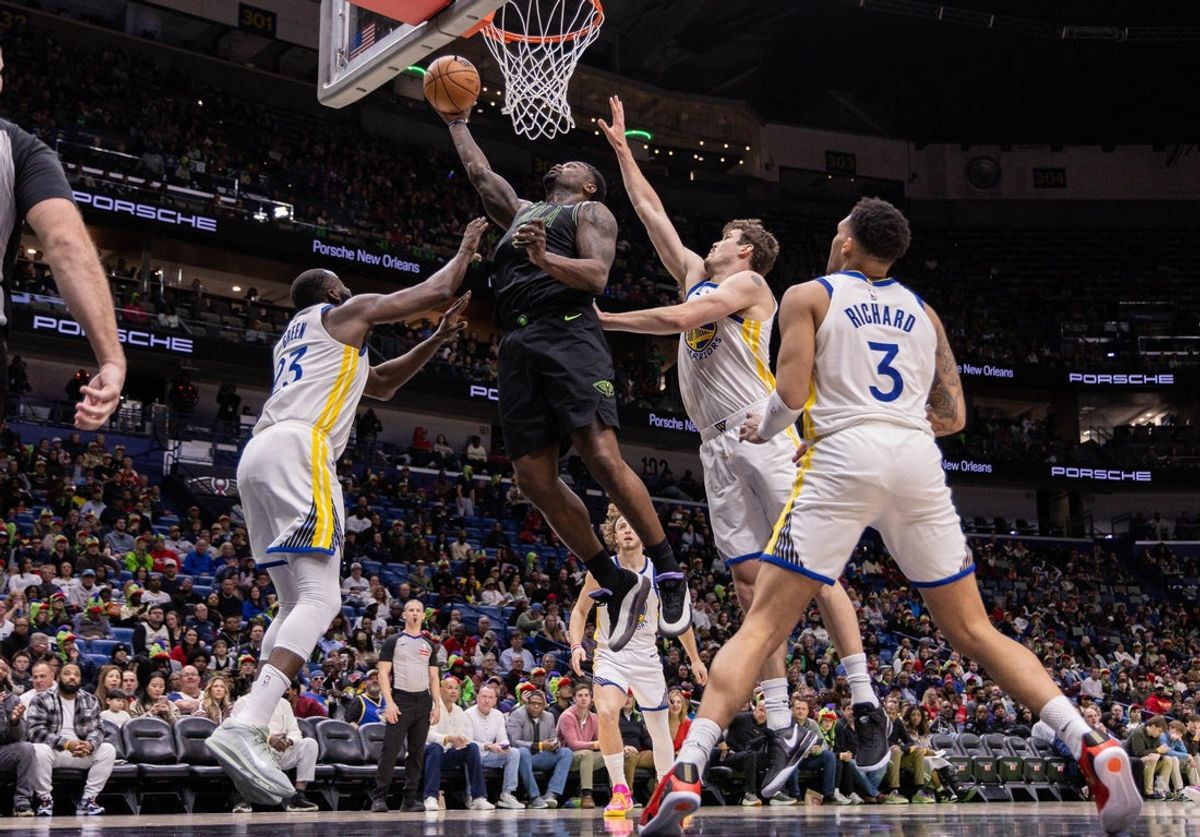 Feb 24, 2026; New Orleans, Louisiana, USA;  New Orleans Pelicans forward Zion Williamson (1) drives to the basket against Golden State Warriors forward Draymond Green (23) during the first half at Smoothie King Center. Mandatory Credit: Stephen Lew-Imagn Images