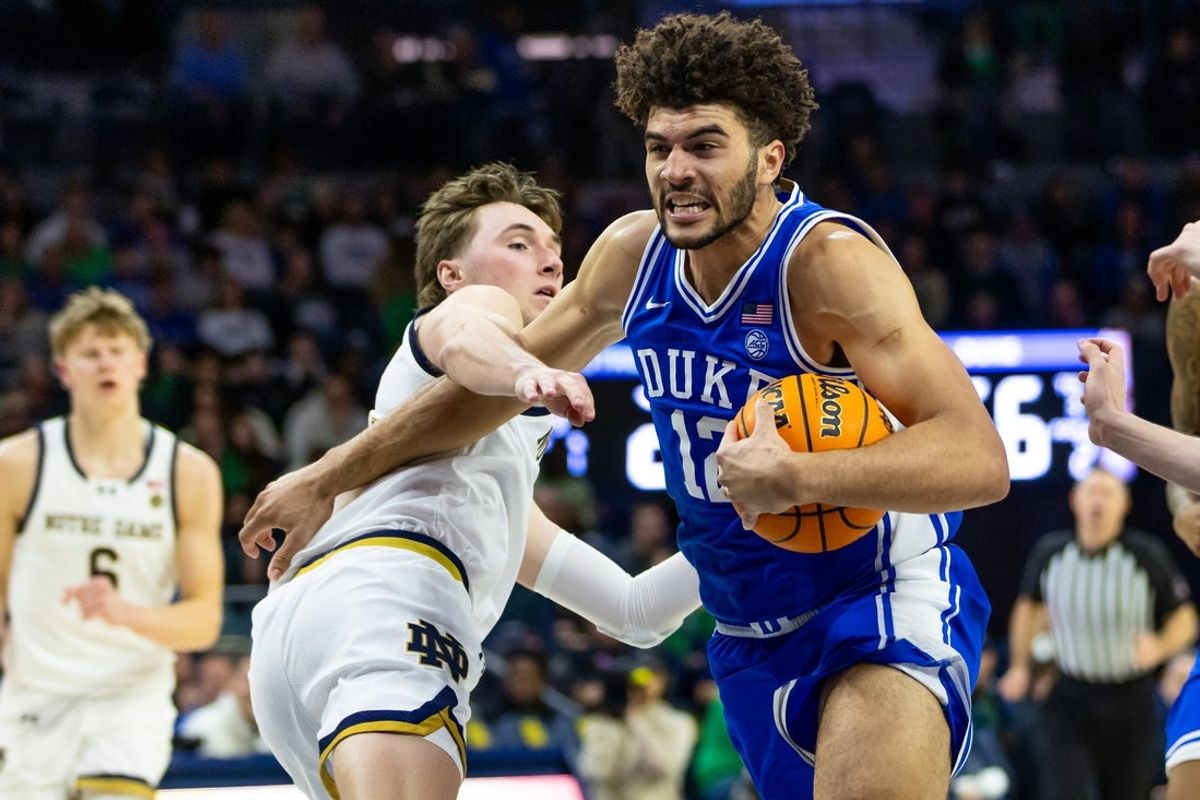 Feb 24, 2026; South Bend, Indiana, USA; Duke Blue Devils forward Cameron Boozer (12) drives as Notre Dame Fighting Irish guard Cole Certa (5) defends during the second half at Purcell Pavilion at the Joyce Center. Mandatory Credit: Michael Caterina-Imagn Images
