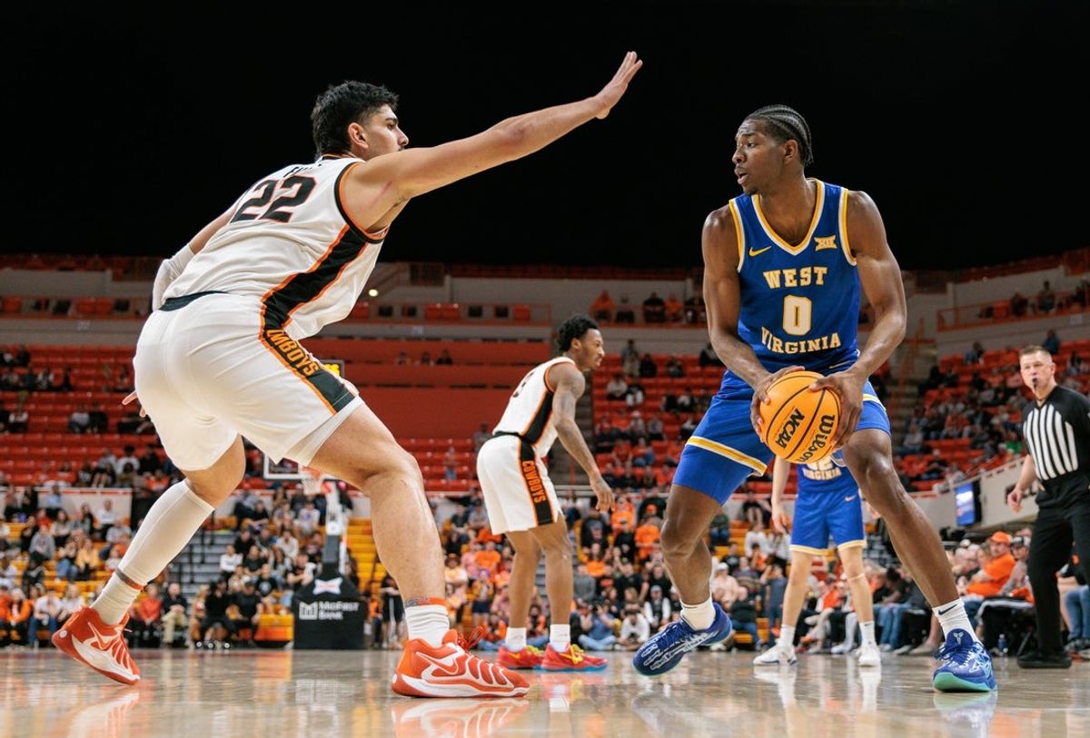 Feb 24, 2026; Stillwater, Oklahoma, USA; West Virginia Mountaineers forward Brenen Lorient (0) drives around Oklahoma State Cowboys forward Parsa Fallah (22) during the second half at Gallagher-Iba Arena. Mandatory Credit: William Purnell-Imagn Images