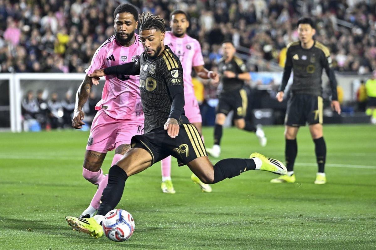 Feb 21, 2026; Los Angeles, California, USA; Los Angeles FC forward Denis Bouanga (99) looks to kick the ball while Inter Miami CF defender Micael (16) defends during the first half at Los Angeles Memorial Coliseum. Mandatory Credit: Kelvin Kuo-Imagn Images