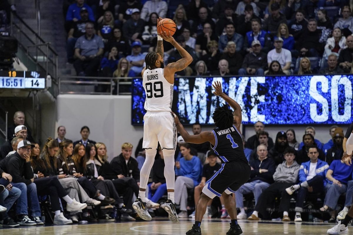 Feb 24, 2026; Provo, Utah, USA; UCF Knights forward Jordan Burks (99) takes a three point shot during the first half against the BYU Cougars at Marriott Center. Mandatory Credit: Aaron Baker-Imagn Images