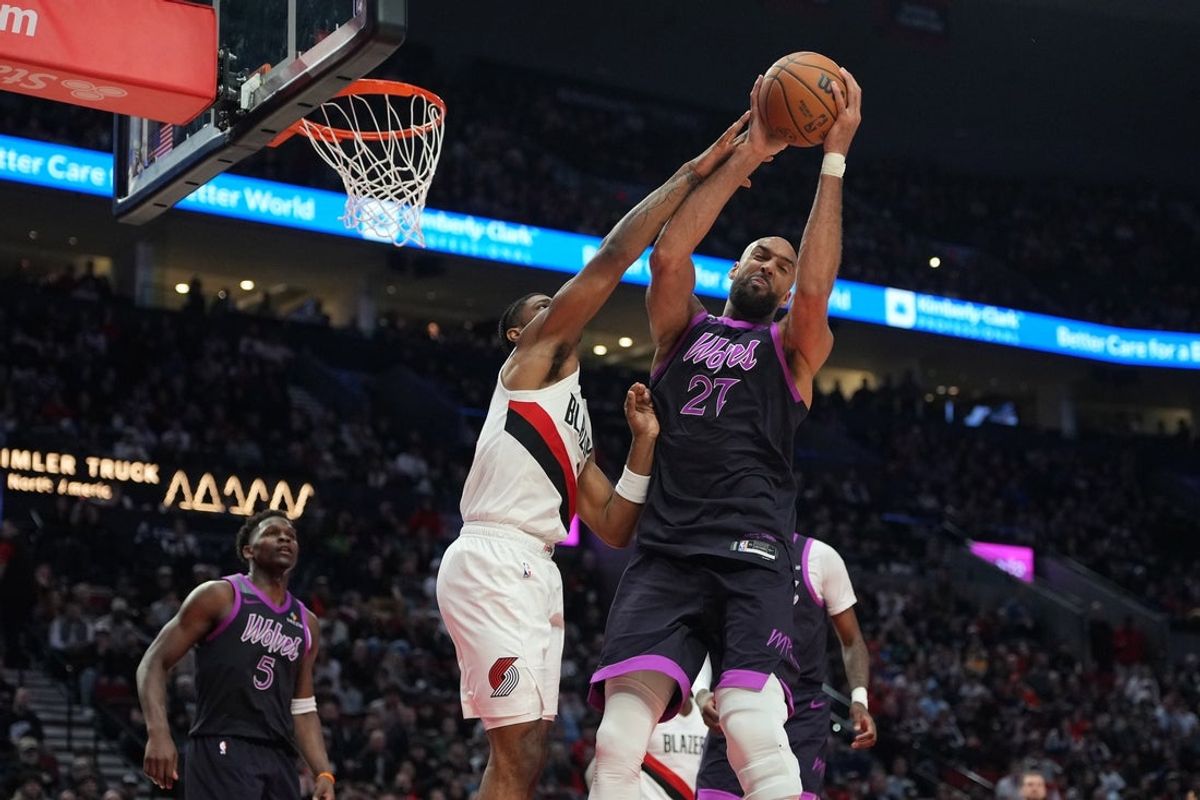 Feb 24, 2026; Portland, Oregon, USA; Minnesota Timberwolves center Rudy Gobert (27) grabs a rebound against Portland Trail Blazers guard Scoot Henderson (00) during the second half at Moda Center. Mandatory Credit: Soobum Im-Imagn Images