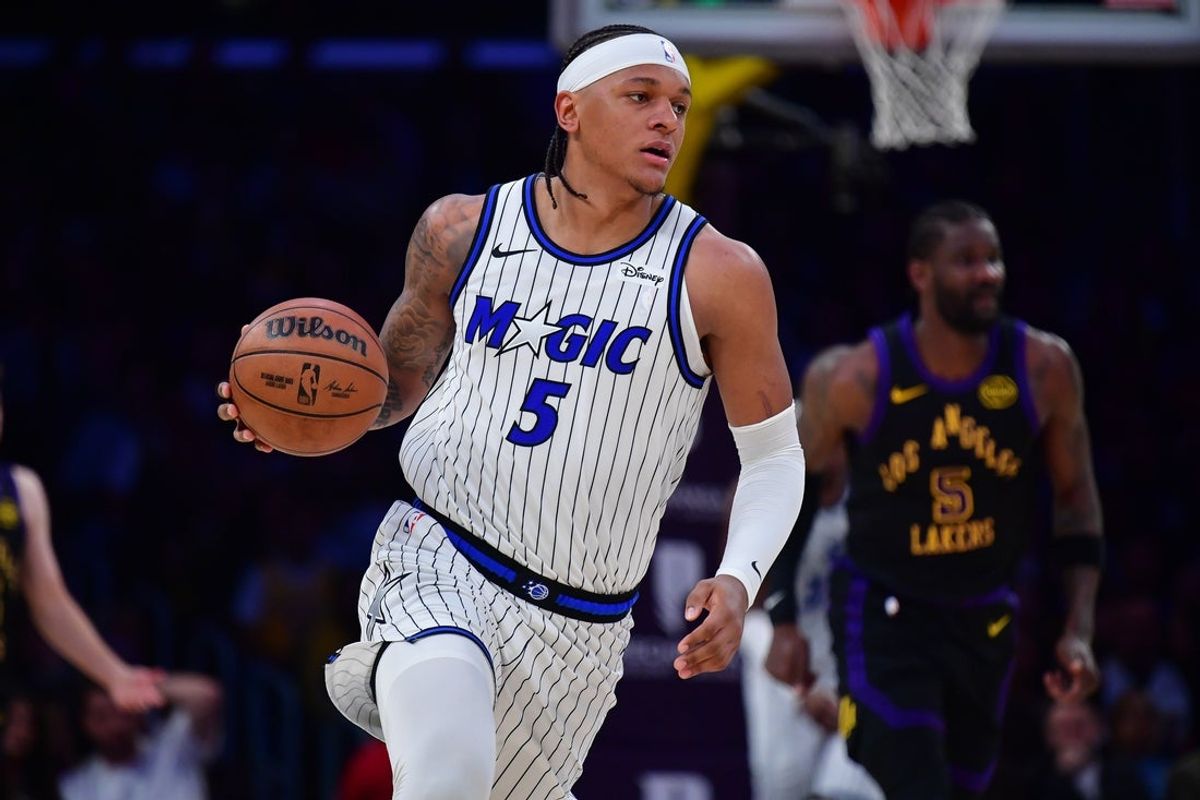 Feb 24, 2026; Los Angeles, California, USA; Orlando Magic forward Paolo Banchero (5) moves the ball up court against the Los Angeles Lakers during the first half at Crypto.com Arena. Mandatory Credit: Gary A. Vasquez-Imagn Images