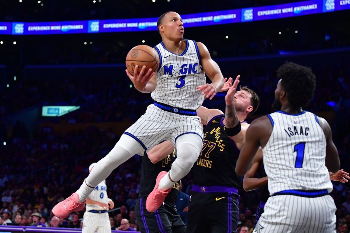 Feb 24, 2026; Los Angeles, California, USA; Orlando Magic guard Desmond Bane (3) moves to the basket against Los Angeles Lakers guard Luka Doncic (77) during the first half at Crypto.com Arena. Mandatory Credit: Gary A. Vasquez-Imagn Images