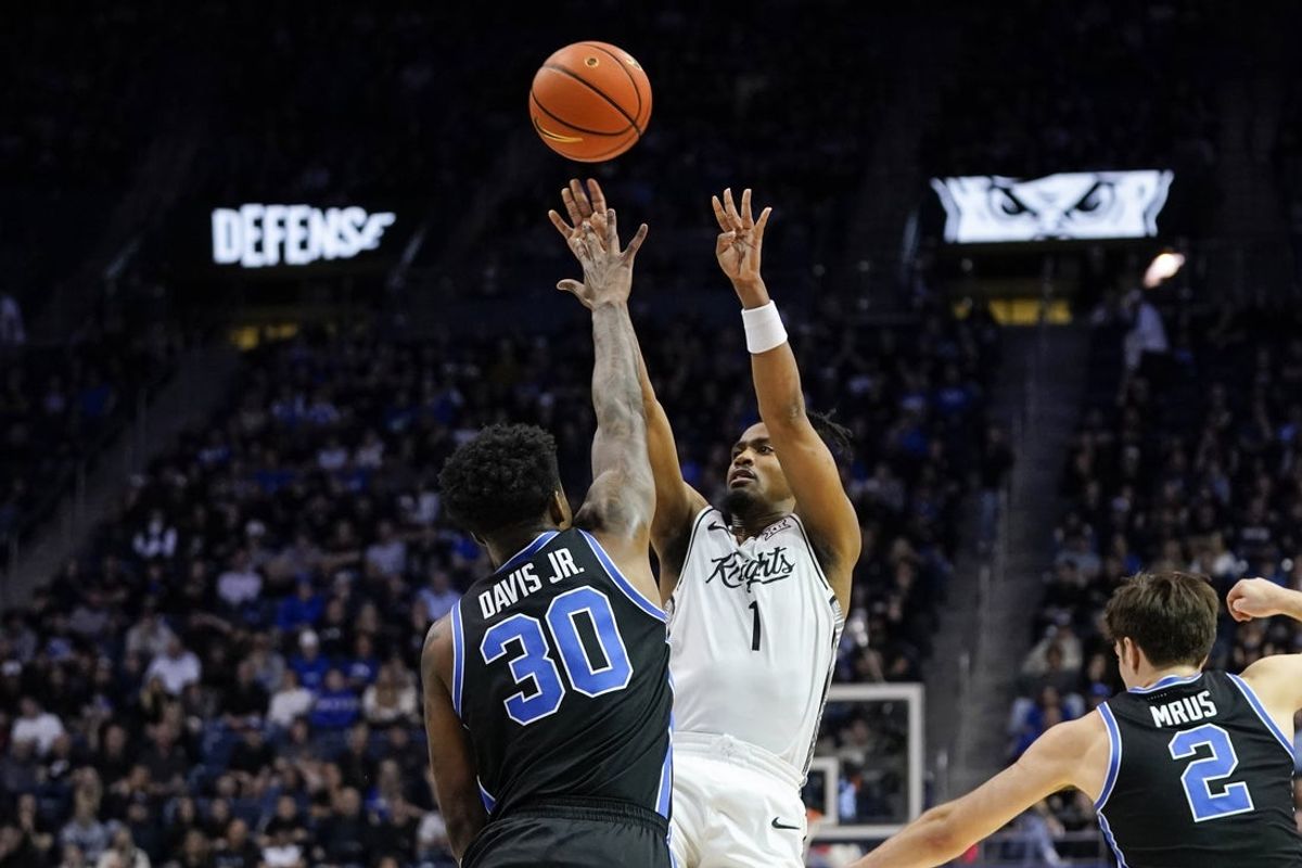 Feb 24, 2026; Provo, Utah, USA; UCF Knights guard Themus Fulks (1) shoots the ball while being defended by BYU Cougars forward Kennard Davis Jr. (30) during the second half at Marriott Center. Mandatory Credit: Aaron Baker-Imagn Images