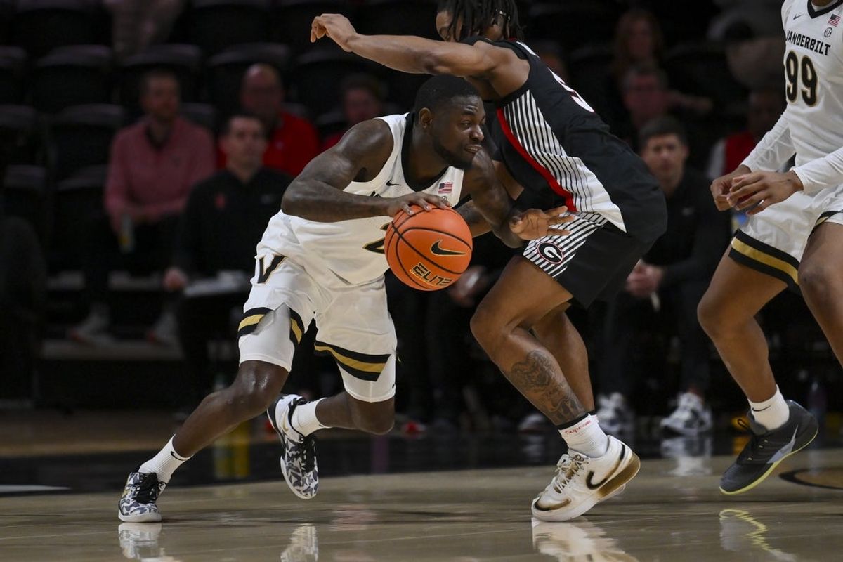 Feb 25, 2026; Nashville, Tennessee, USA;  Vanderbilt Commodores guard Duke Miles (2) goes under the arm of Georgia Bulldogs guard Jeremiah Wilkinson (5) during the first half at Memorial Gymnasium. Mandatory Credit: Steve Roberts-Imagn Images