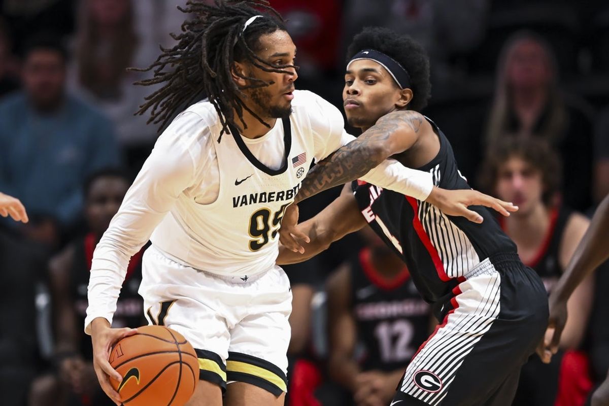 Feb 25, 2026; Nashville, Tennessee, USA;  Vanderbilt Commodores forward Devin McGlockton (99) backs down Georgia Bulldogs guard Marcus Millender (4) during the first half at Memorial Gymnasium. Mandatory Credit: Steve Roberts-Imagn Images