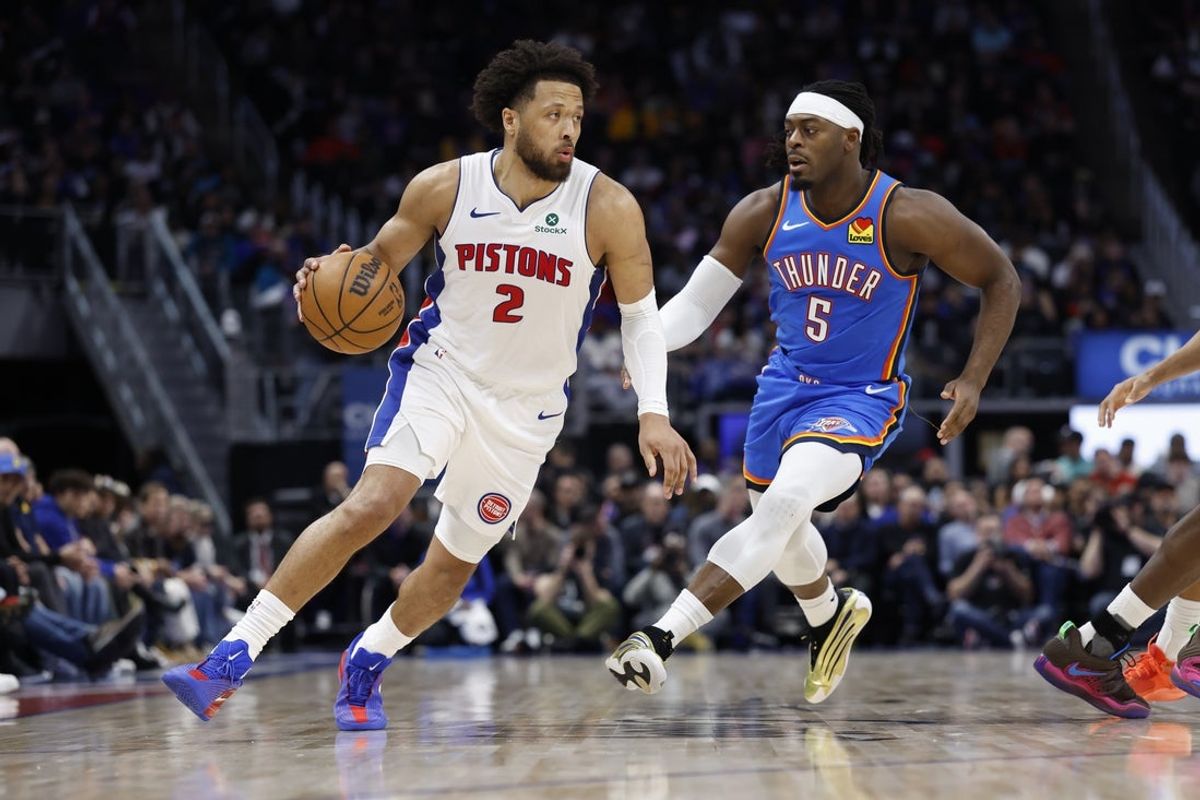 Feb 25, 2026; Detroit, Michigan, USA;  Detroit Pistons guard Cade Cunningham (2) dribbles on Oklahoma City Thunder guard Luguentz Dort (5) in the first half at Little Caesars Arena. Mandatory Credit: Rick Osentoski-Imagn Images