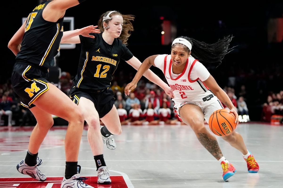 Ohio State Buckeyes guard Chance Gray (2) drives past Michigan Wolverines guard Syla Swords (12) during the NCAA women's basketball game at the Jerome Schottenstein Center on Feb. 25, 2026.