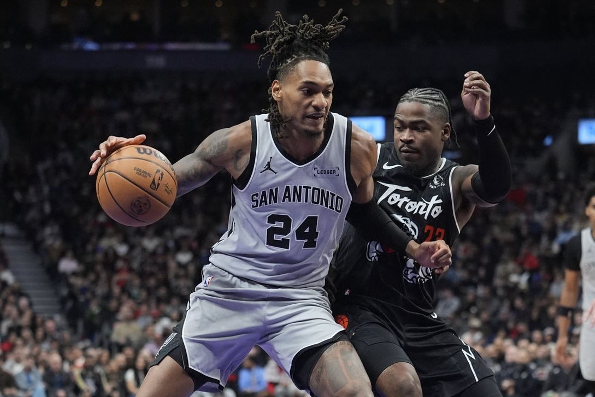 Feb 25, 2026; Toronto, Ontario, CAN; San Antonio Spurs guard Devin Vassell (24) controls the ball against Toronto Raptors guard Jamal Shead (23) during the first half at Scotiabank Arena. Mandatory Credit: John E. Sokolowski-Imagn Images