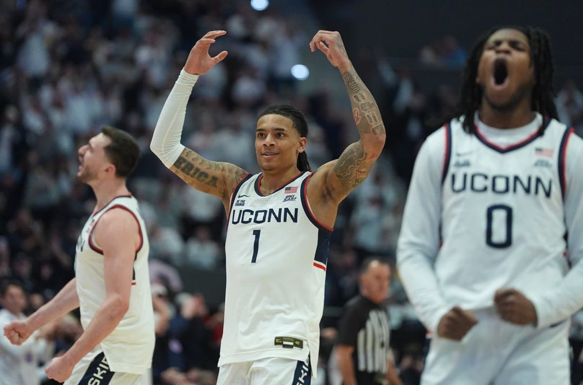 Feb 25, 2026; Hartford, Connecticut, USA; UConn Huskies guard Solo Ball (1) , guard Malachi Smith (0) and forward Alex Karaban (11) react during a break against the St. John's Red Storm in the second half at PeoplesBank Arena. Mandatory Credit: David Butler II-Imagn Images