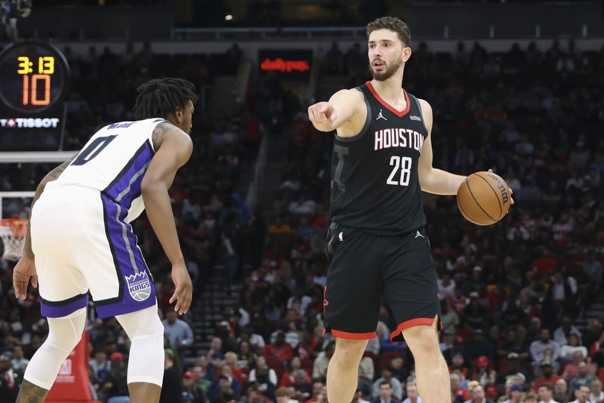 Feb 25, 2026; Houston, Texas, USA; Houston Rockets center Alperen Sengun (28) dribbles the ball as Sacramento Kings guard Malik Monk (0) defends during the second quarter at Toyota Center. Mandatory Credit: Troy Taormina-Imagn Images