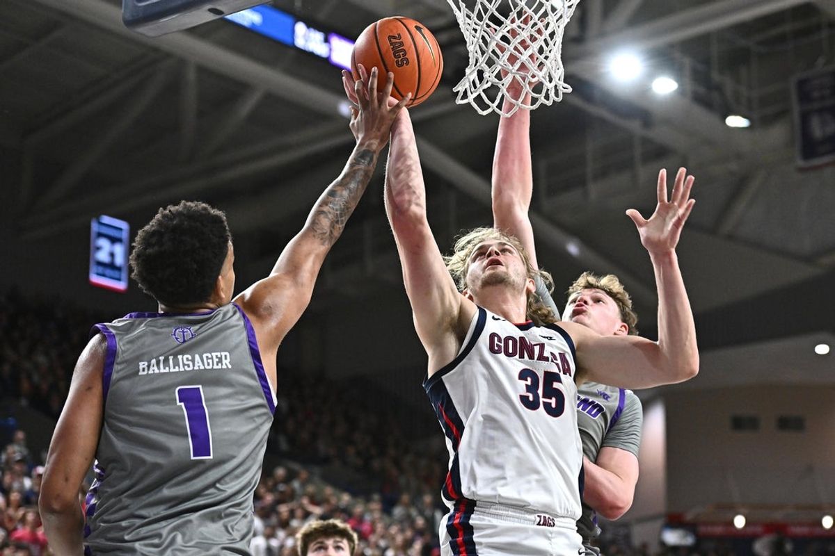 Feb 25, 2026; Spokane, Washington, USA; Gonzaga Bulldogs forward Noah Haaland (35) shoots the ball against Portland Pilots center Jermaine Ballisager Webb (1) in the first half at McCarthey Athletic Center. Mandatory Credit: James Snook-Imagn Images