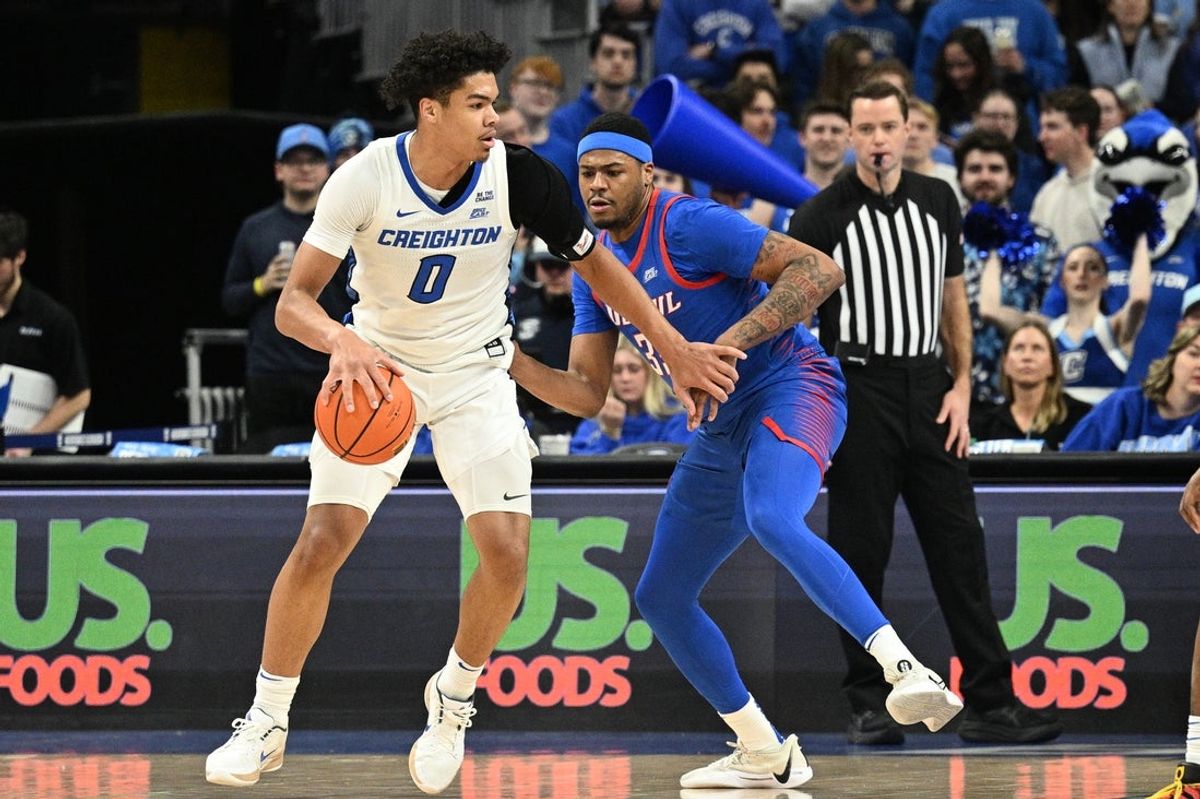 Feb 25, 2026; Omaha, Nebraska, USA;  Creighton Bluejays forward Jasen Green (0) drives against DePaul Blue Demons forward N.J. Benson (35) during the first half at CHI Health Center Omaha. Mandatory Credit: Steven Branscombe-Imagn Images