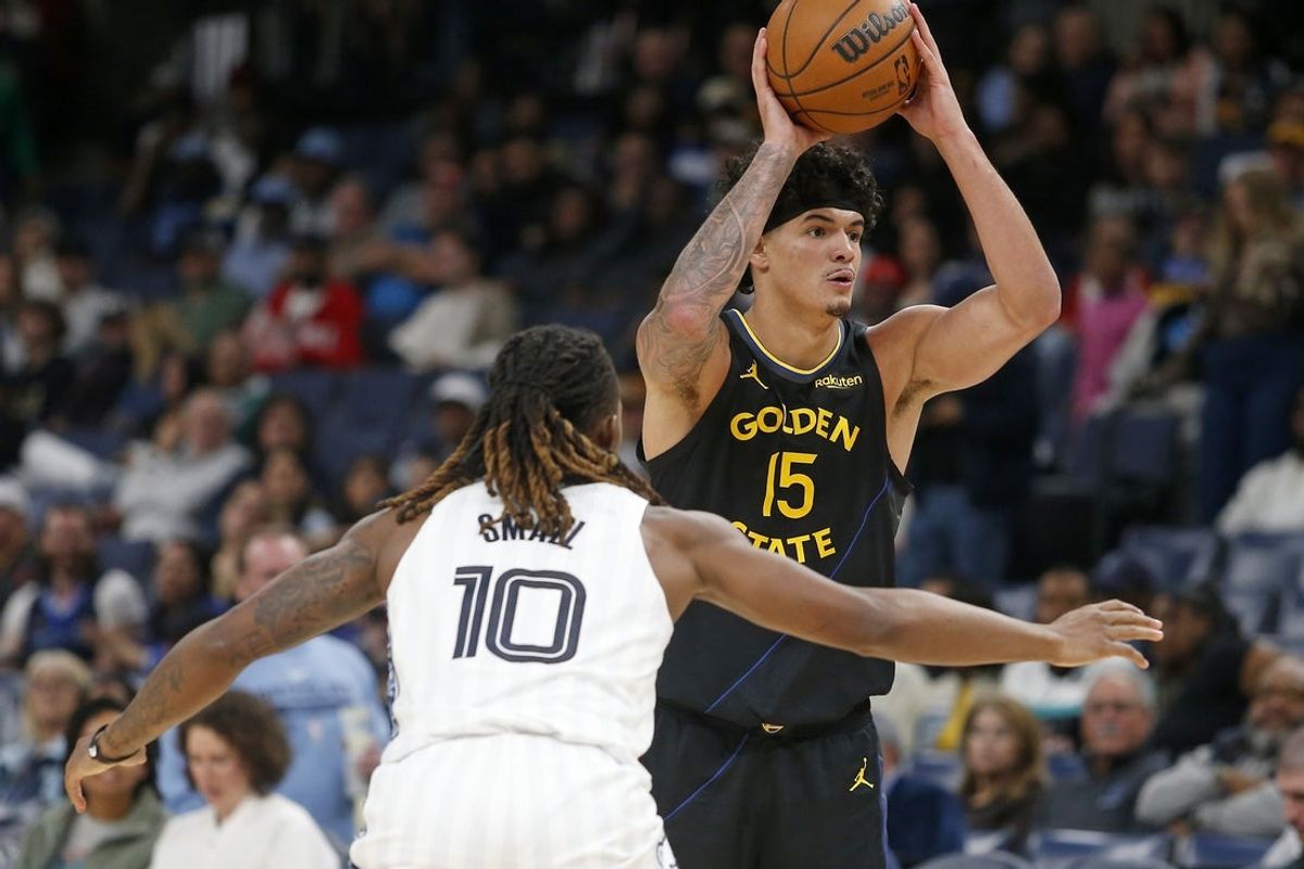Feb 25, 2026; Memphis, Tennessee, USA; Golden State Warriors forward Gui Santos (15) passes the ball as Memphis Grizzlies guard Javon Small (10) defends during the third quarter at FedExForum. Mandatory Credit: Petre Thomas-Imagn Images