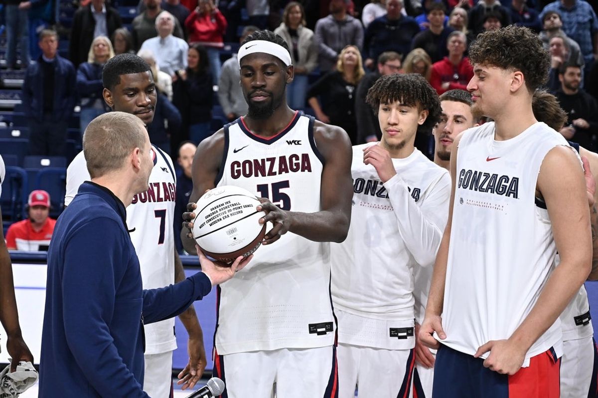 Feb 25, 2026; Spokane, Washington, USA; Gonzaga Bulldogs forward Graham Ike (15) is awarded a basket for “most consecutive 20-point game in modern era” after a game against the Portland Pilots at McCarthey Athletic Center. Gonzaga Bulldogs won 89-48. Mandatory Credit: James Snook-Imagn Images