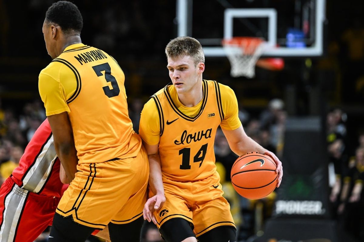 Feb 25, 2026; Iowa City, Iowa, USA; Iowa Hawkeyes guard Bennett Stirtz (14) controls the ball as forward Cam Manyawu (3) sets a screen against the Ohio State Buckeyes during the second half at Carver-Hawkeye Arena. Mandatory Credit: Jeffrey Becker-Imagn Images