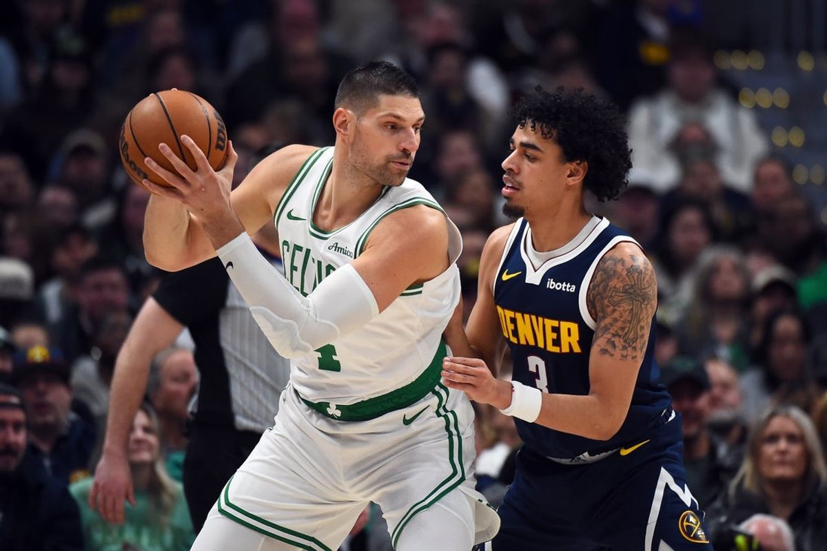 Feb 25, 2026; Denver, Colorado, USA; Boston Celtics center Nikola Vucevic (4) works in the post against Denver Nuggets guard Julian Strawther (3) during the first half at Ball Arena. Mandatory Credit: Christopher Hanewinckel-Imagn Images