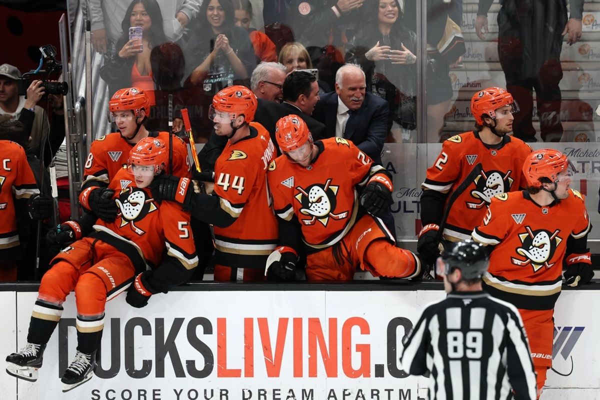 Feb 25, 2026; Anaheim, California, USA;  Anaheim Ducks head coach Joel Quenneville (back row, right) celebrates with his coaching staff after winning his 1,000th career coaching victory with a 6-5 win over the Edmonton Oilers at Honda Center. Mandatory Credit: Kiyoshi Mio-Imagn Images