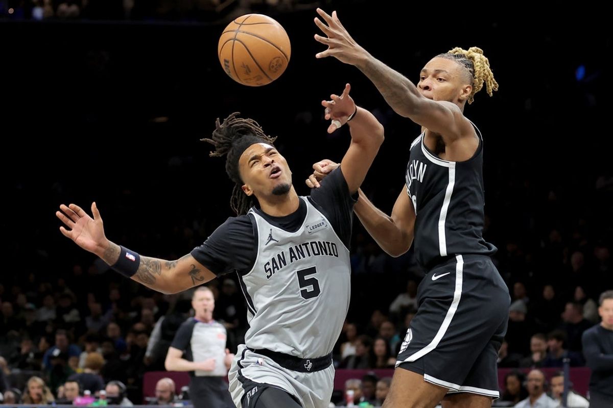 Feb 26, 2026; Brooklyn, New York, USA; San Antonio Spurs guard Stephon Castle (5) is fouled by Brooklyn Nets forward Noah Clowney (21) as he drives to the basket during the first quarter at Barclays Center. Mandatory Credit: Brad Penner-Imagn Images