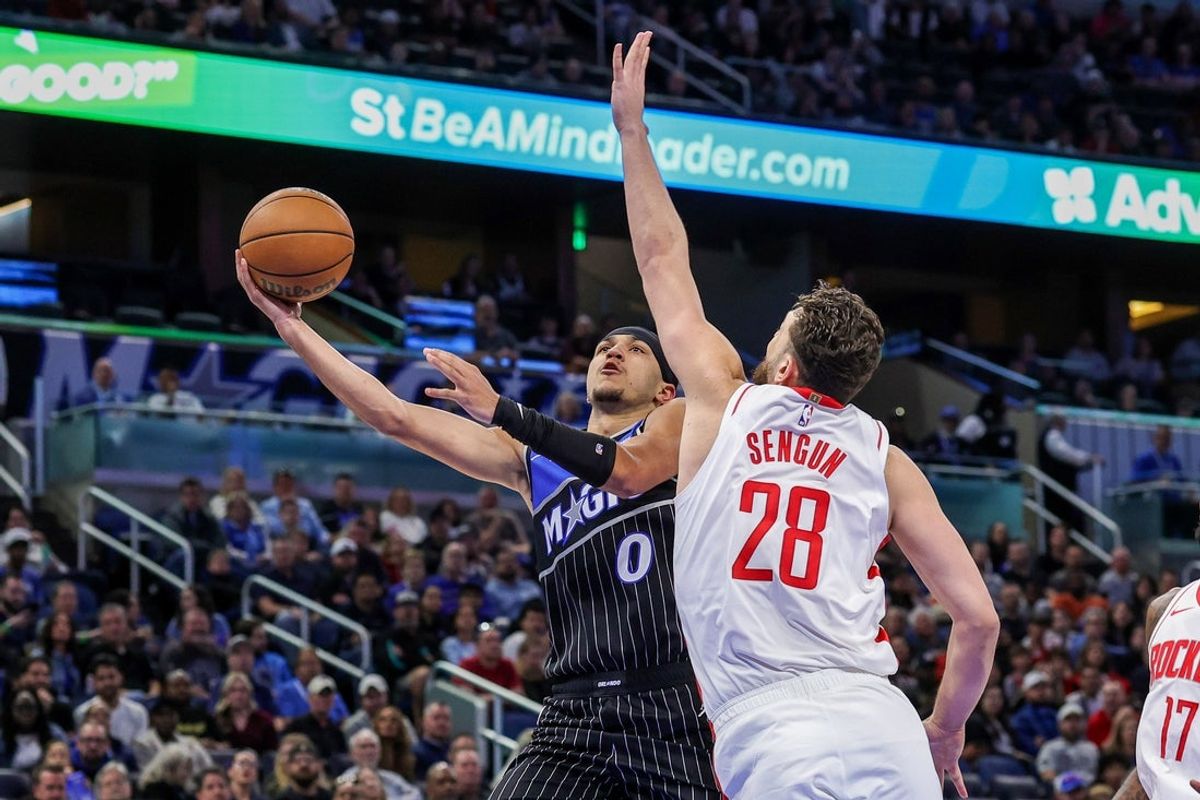 Feb 26, 2026; Orlando, Florida, USA; Orlando Magic guard Anthony Black (0) goes to the basket against Houston Rockets center Alperen Sengun (28) during the first quarter at Kia Center. Mandatory Credit: Mike Watters-Imagn Images
