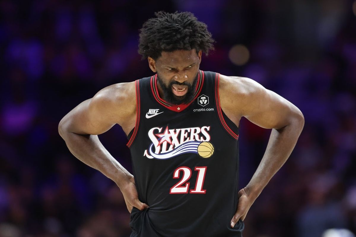 Feb 26, 2026; Philadelphia, Pennsylvania, USA; Philadelphia 76ers center Joel Embiid (21) reacts while clutching his body after a play against the Miami Heat during the second quarter at Xfinity Mobile Arena. Mandatory Credit: Bill Streicher-Imagn Images