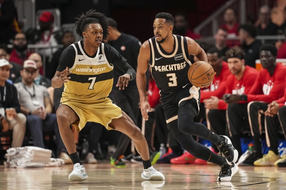 Feb 26, 2026; Atlanta, Georgia, USA; Atlanta Hawks guard CJ McCollum (3) dribbles against Washington Wizards guard Bub Carrington (7) during the first half at State Farm Arena. Mandatory Credit: Dale Zanine-Imagn Images