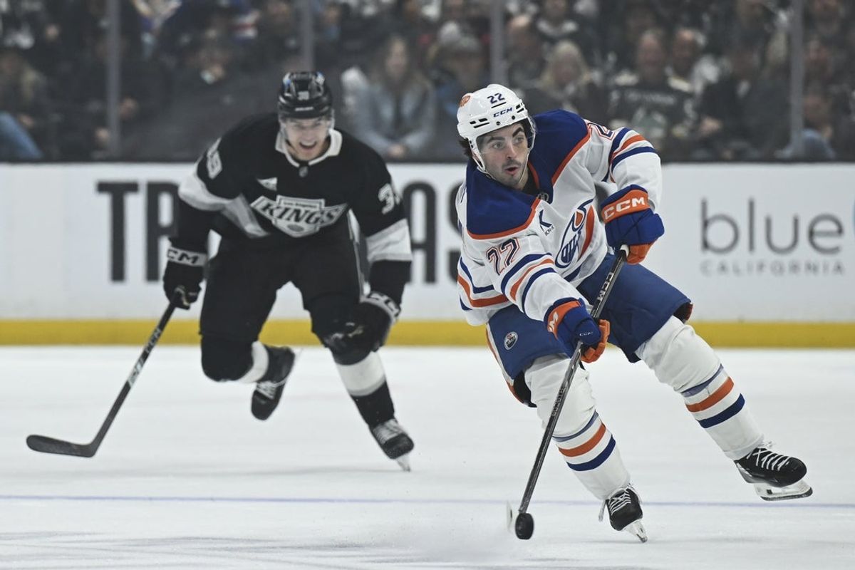 Feb 26, 2026; Los Angeles, California, USA; Edmonton Oilers center Matt Savoie (22) advances the puck down ice against the Los Angeles Kings during the first period at Crypto.com Arena. Mandatory Credit: Griffin Hooper-Imagn Images