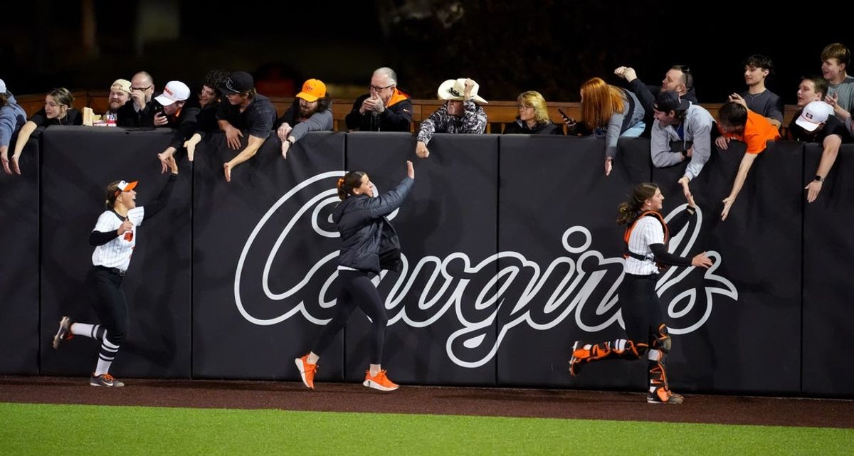 Oklahoma State celebrates with fans following the college softball game between the Oklahoma State University Cowgirls and the Nebraska Cornhuskers in Stillwater, Okla., Thursday Feb. 26, 2026.