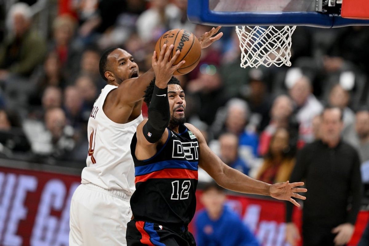 Feb 27, 2026; Detroit, Michigan, USA;  Detroit Pistons forward Tobias Harris (12) drives to the basket against past Cleveland Cavaliers center Evan Mobley (4) in the first half at Little Caesars Arena. Mandatory Credit: Lon Horwedel-Imagn Images