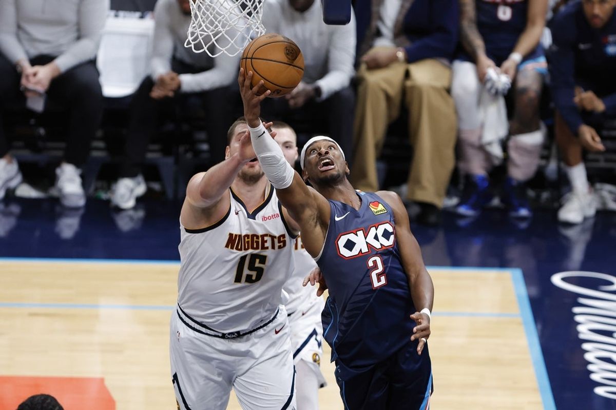 Feb 27, 2026; Oklahoma City, Oklahoma, USA; Oklahoma City Thunder guard Shai Gilgeous-Alexander (2) goes up for a basket in front of Denver Nuggets center Nikola Jokic (15) during the fourth quarter at Paycom Center. Mandatory Credit: Alonzo Adams-Imagn Images