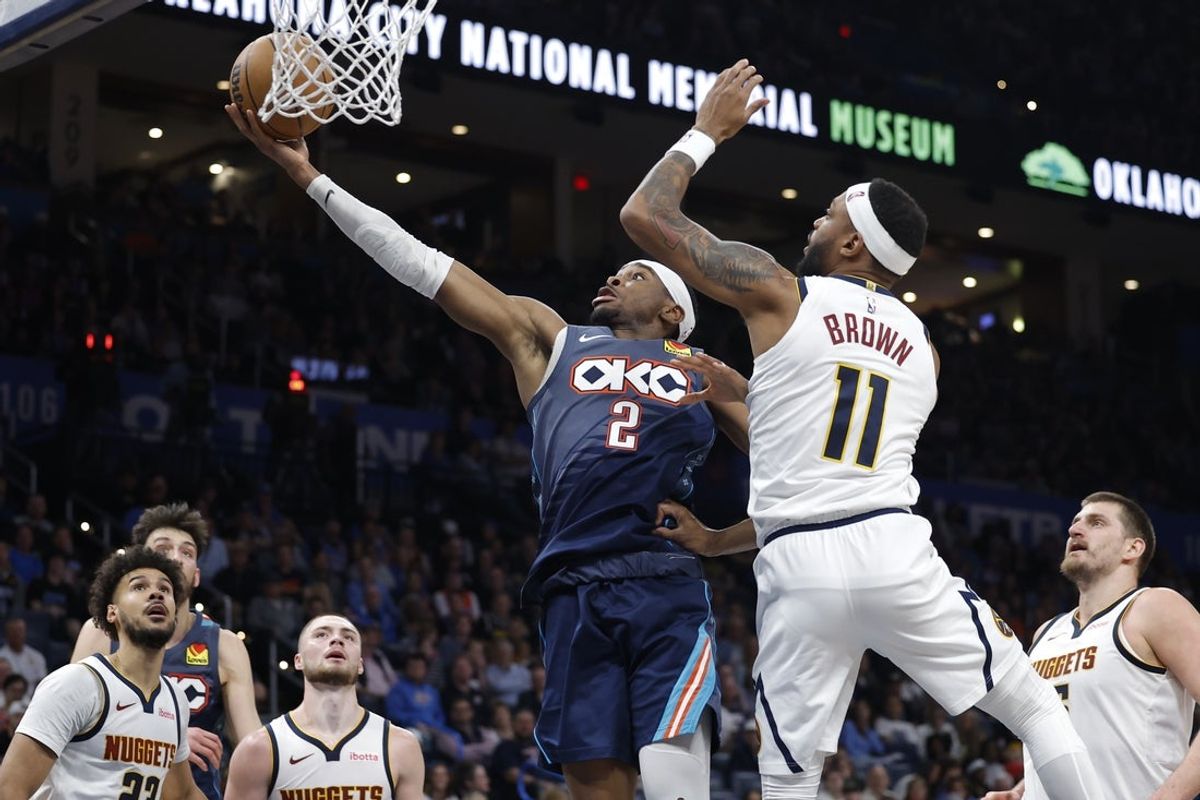 Feb 27, 2026; Oklahoma City, Oklahoma, USA; Oklahoma City Thunder guard Shai Gilgeous-Alexander (2) goes up for a basket beside Denver Nuggets guard/forward Bruce Brown (11) during the third quarter at Paycom Center. Mandatory Credit: Alonzo Adams-Imagn Images