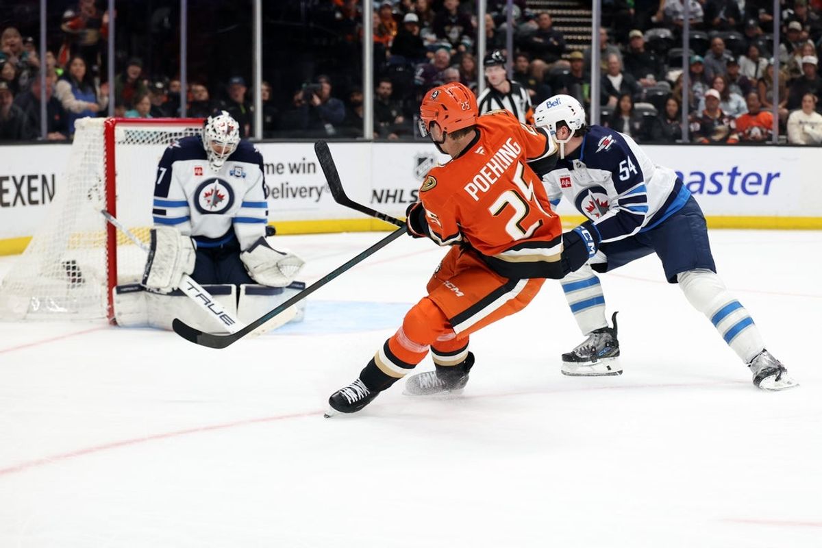 Feb 27, 2026; Anaheim, California, USA;  Anaheim Ducks center Ryan Poehling (25) shoots and scores a goal against Winnipeg Jets goaltender Connor Hellebuyck (37) during the third period at Honda Center. Mandatory Credit: Kiyoshi Mio-Imagn Images