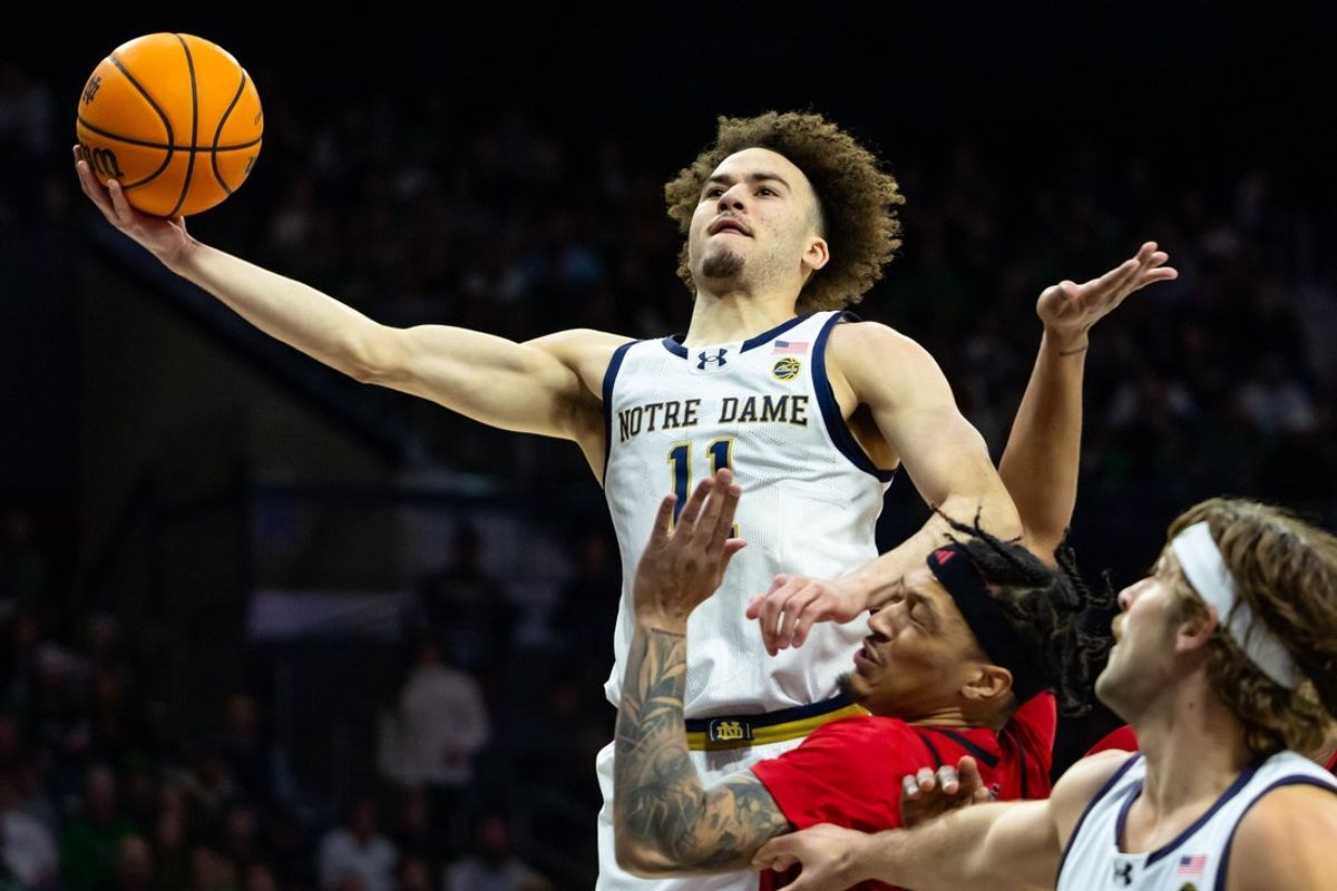 Feb 28, 2026; South Bend, Indiana, USA; Notre Dame Fighting Irish guard Braeden Shrewsberry (11) drives as NC State Wolfpack forward Darrion Williams (1) defends during the first half at Purcell Pavilion at the Joyce Center. Mandatory Credit: Michael Caterina-Imagn Images
