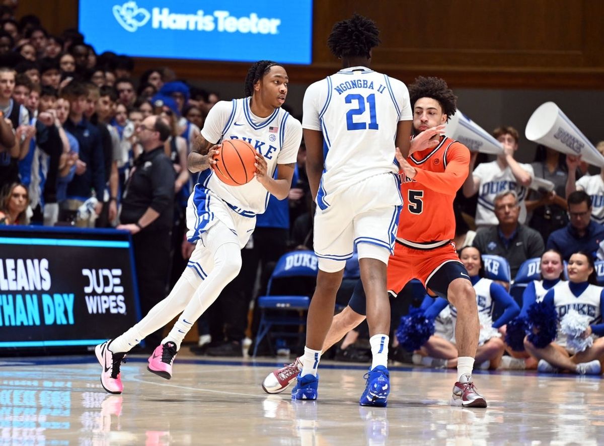 Feb 28, 2026; Durham, North Carolina, USA; Duke Blue Devils forward Isaiah Evans (3) grabs a pass as he moves around a pick center Patrick Ngongba II (21) as Virginia Cavaliers guard Sam Lewis (5) defends during the first half at Cameron Indoor Stadium. Mandatory Credit: Rob Kinnan-Imagn Images