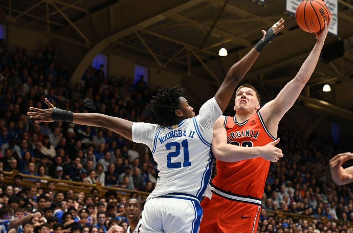 Feb 28, 2026; Durham, North Carolina, USA; Virginia Cavaliers forward Thijs De Ridder (28) shoots over Duke Blue Devils center Patrick Ngongba II (21) during the first half at Cameron Indoor Stadium. Mandatory Credit: Rob Kinnan-Imagn Images