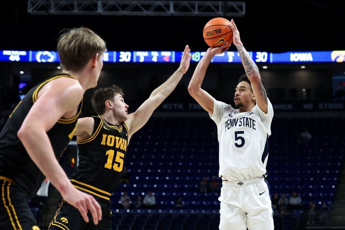 Feb 28, 2026; University Park, Pennsylvania, USA; Penn State Nittany Lions guard Freddie Dilione V (5) attempts a three-point shot as Iowa Hawkeyes guard Brendan Hausen (15) defends during the first half at Bryce Jordan Center. Mandatory Credit: Matthew O'Haren-Imagn Images