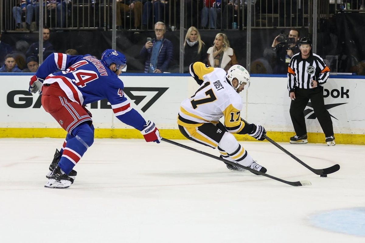 Feb 28, 2026; New York, New York, USA;  New York Rangers defenseman Vladislav Gavrikov (44) and Pittsburgh Penguins right wing Bryan Rust (17) chase the puck in the first period at Madison Square Garden. Mandatory Credit: Wendell Cruz-Imagn Images