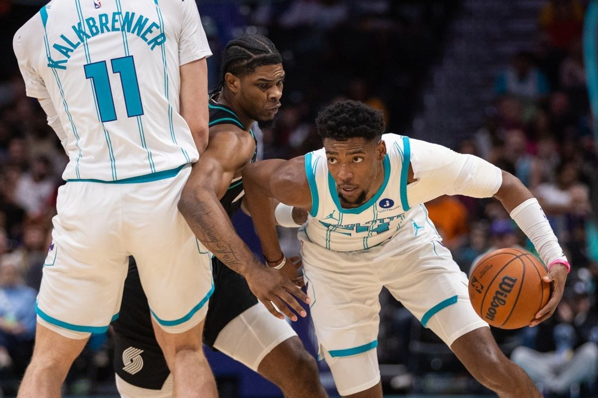 Feb 28, 2026; Charlotte, North Carolina, USA; Charlotte Hornets forward Brandon Miller (24) uses a screen from center Ryan Kalkbrenner (11) against Portland Trail Blazers guard Caleb Love (2) during the first quarter at Spectrum Center. Mandatory Credit: Scott Kinser-Imagn Images