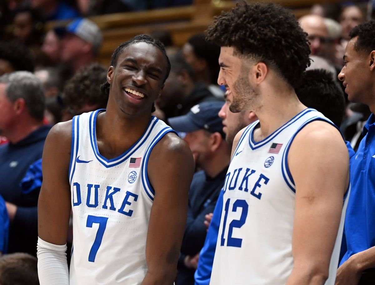 Feb 28, 2026; Durham, North Carolina, USA; Duke Blue Devils forward Dame Sarr (7) and forward Cameron Boozer (12) joke during the second half against the Virginia Cavaliers at Cameron Indoor Stadium.   Duke won 77-51.  Mandatory Credit: Rob Kinnan-Imagn Images