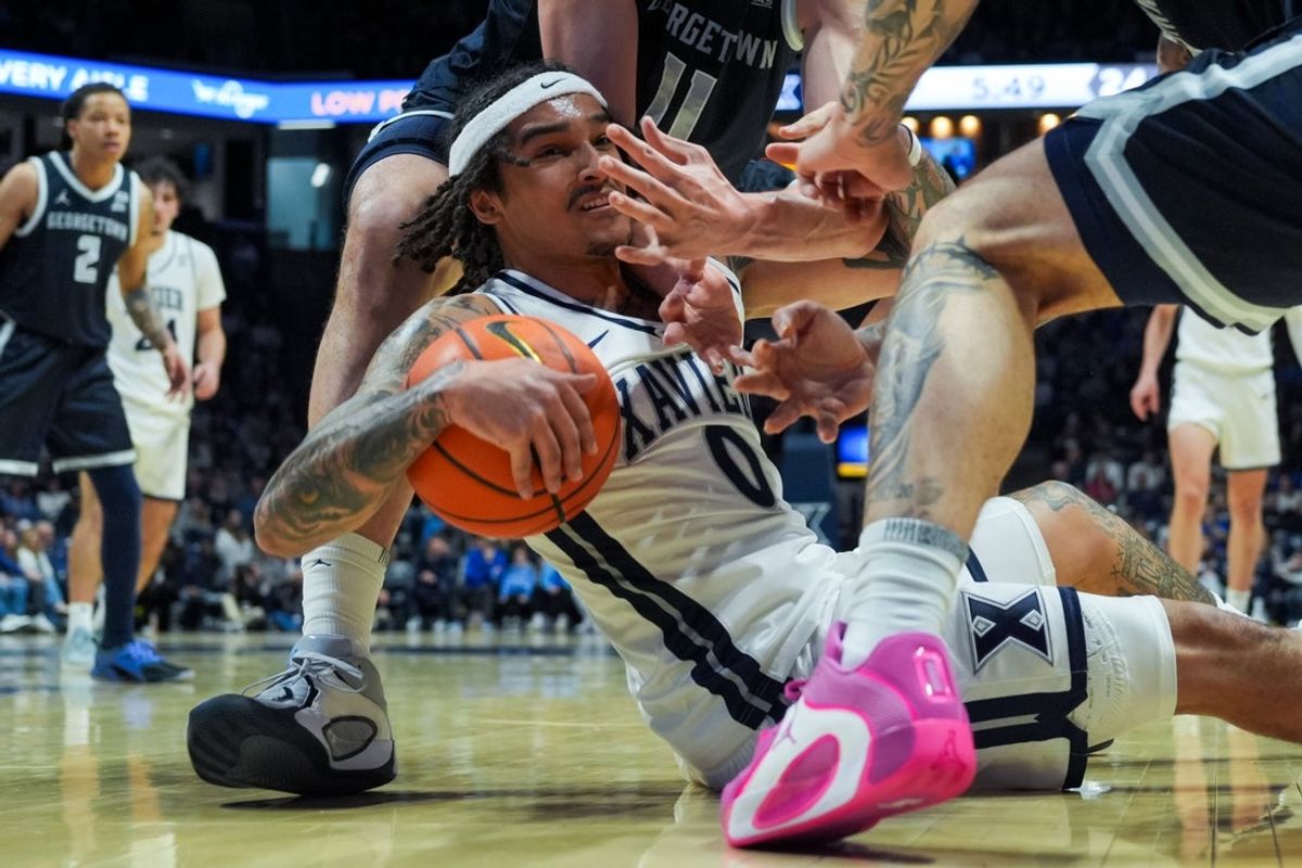 Feb 28, 2026; Cincinnati, Ohio, USA; Xavier Musketeers guard Roddie Anderson III (0) battles for the loose ball against the Georgetown Hoyas in the first half at the Cintas Center. Mandatory Credit: Aaron Doster-Imagn Images