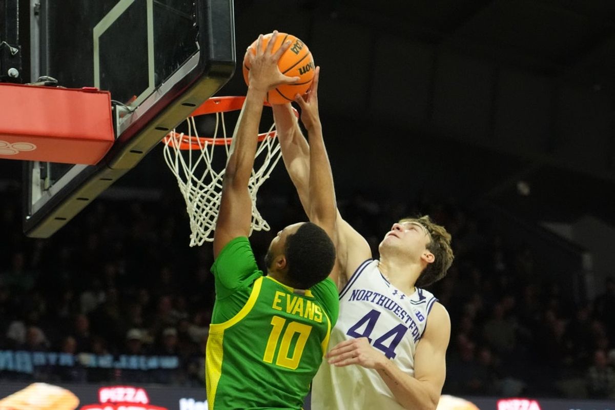 Feb 28, 2026; Evanston, Illinois, USA; Northwestern Wildcats guard Angelo Ciaravino (44) blocks the shot of Oregon Ducks forward Kwame Evans Jr. (10) during the first half at Welsh-Ryan Arena. Mandatory Credit: David Banks-Imagn Images