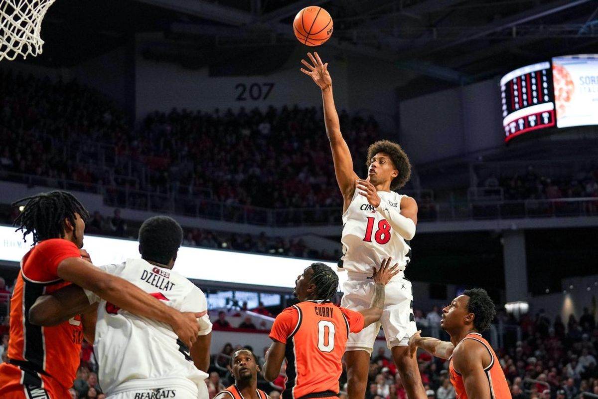 Cincinnati Bearcats forward Baba Miller (18) makes a basket from the two point line in the first half of a NCAA men’s basketball game between the Cincinnati Bearcats and Oklahoma State Cowboys, Saturday, Feb. 28, 2026, at Fifth Third Arena in Cincinnati.