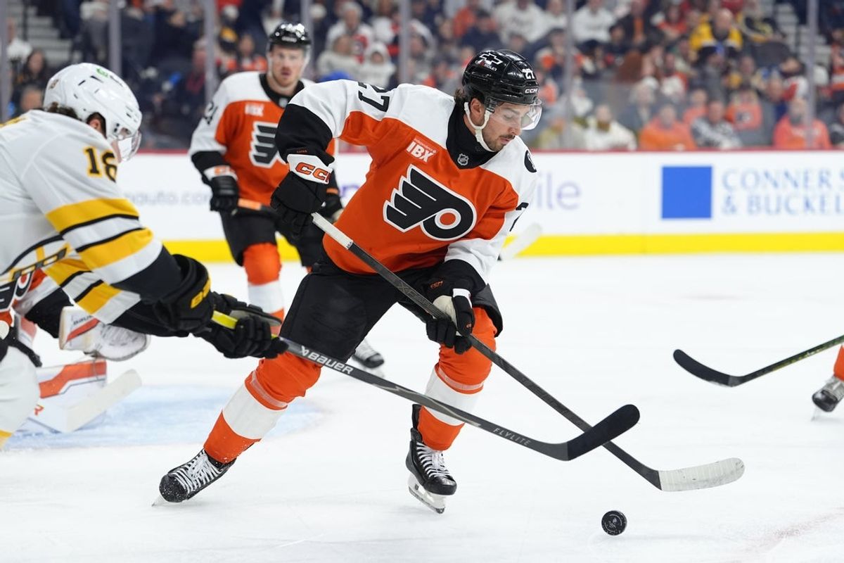 Feb 28, 2026; Philadelphia, Pennsylvania, USA; Philadelphia Flyers left wing Noah Cates (27) reaches for the puck against the Boston Bruins in the first period at Xfinity Mobile Arena. Mandatory Credit: Kyle Ross-Imagn Images