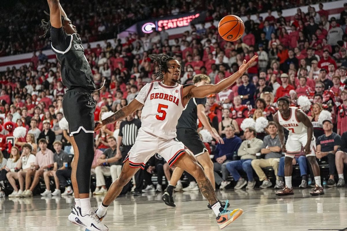 Feb 28, 2026; Athens, Georgia, USA; Georgia Bulldogs guard Jeremiah Wilkinson (5) controls a loose ball against South Carolina Gamecocks guard Kobe Knox (4) during the first half at Stegeman Coliseum. Mandatory Credit: Dale Zanine-Imagn Images