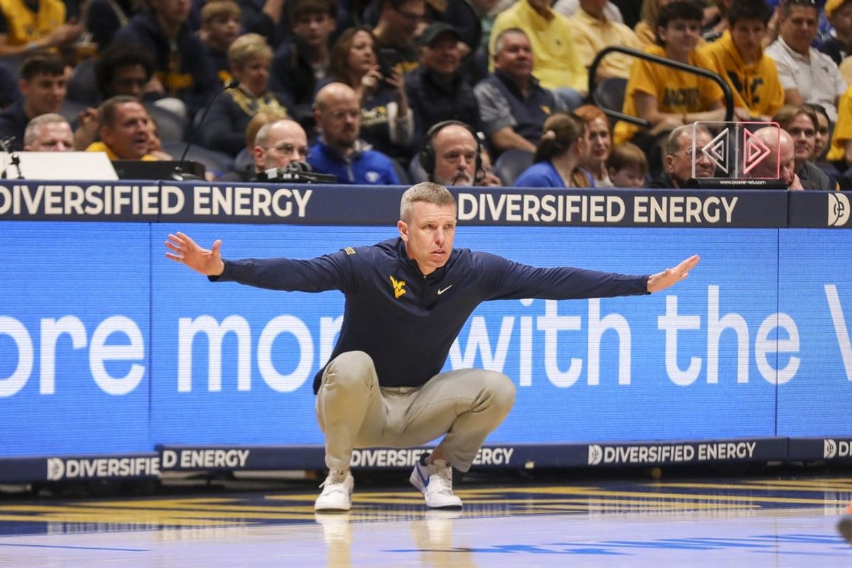 Feb 28, 2026; Morgantown, West Virginia, USA; West Virginia Mountaineers head coach Ross Hodge watched a play from the sideline during the first half against the BYU Cougars at Hope Coliseum. Mandatory Credit: Ben Queen-Imagn Images