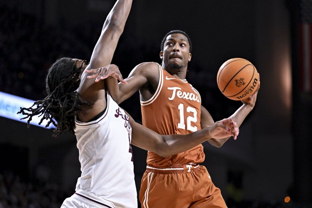 Feb 28, 2026; College Station, Texas, USA; Texas Longhorns guard Tramon Mark (12) attempts to shoot a basket as Texas A&M Aggies forward Jamie Vinson (4) defends during the first half at Reed Arena. Mandatory Credit: Maria Lysaker-Imagn Images